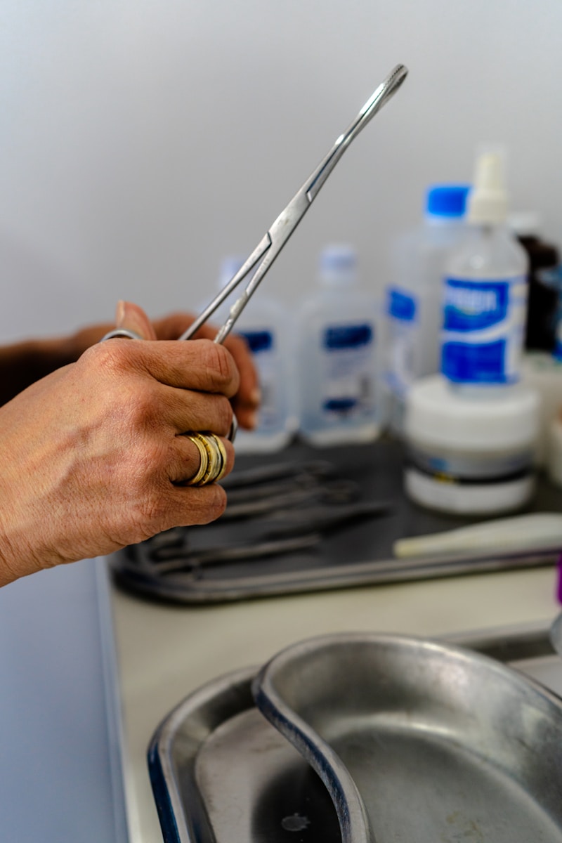 Photo by Mateo Hernandez Reyes a person holding a pair of scissors over a sink